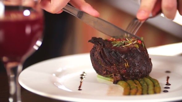 Man Cuts Off a Piece Of Steak 