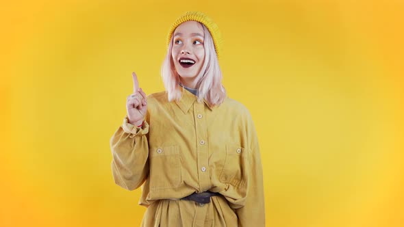 Portrait of Young Thinking Pondering Woman Having Idea Moment Pointing Finger Up