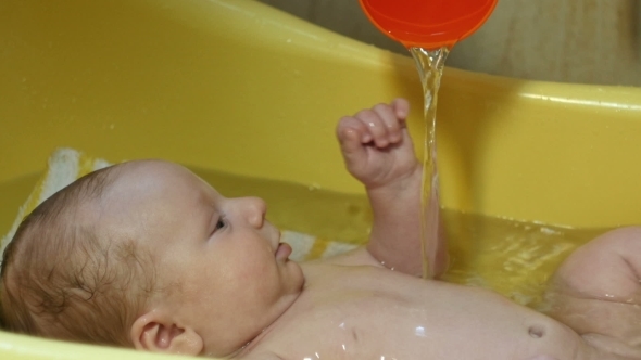 Little Newborn Baby Having a Bath