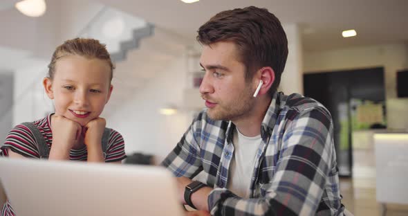 Young Woman Freelancer Working Remotely Using Laptop From Home and Asking Son to Not Disturb