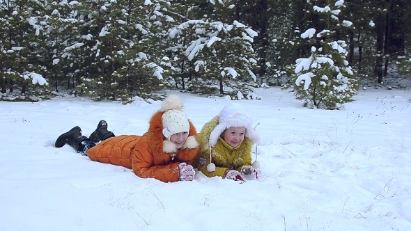 Two Girls Lie On Snow