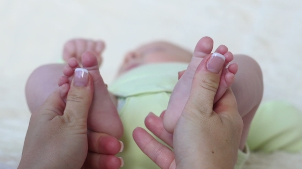 Masseur Massaging Little Baby's Feet