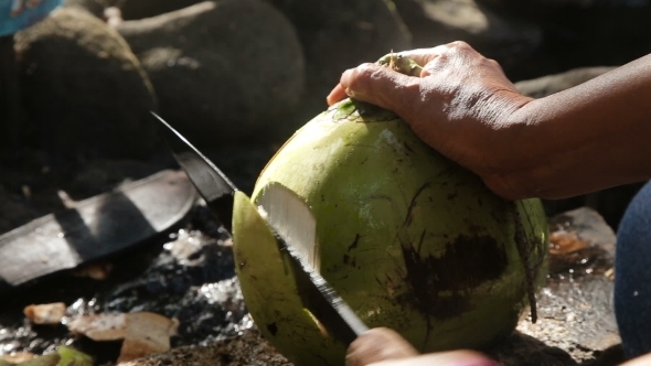 Woman Opening Coconut With Big Knife