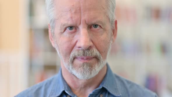 Close Up of Serious Old Man Looking at the Camera 