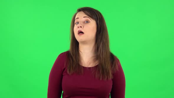çPortrait of Funny Girl Is Smiling Broadly and Winking. Green Screen