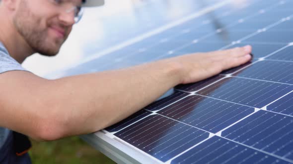 Close Up of an Young Engineer Hand is Checking an Operation of Sun and Cleanliness of Photovoltaic