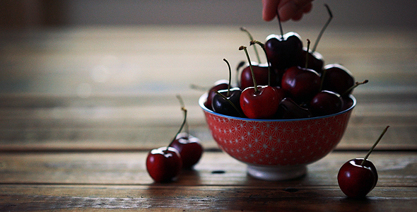 Red Cherries In Bowl On Wooden Table