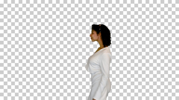 Young black lady in white walks adjusting hair, Alpha Channel