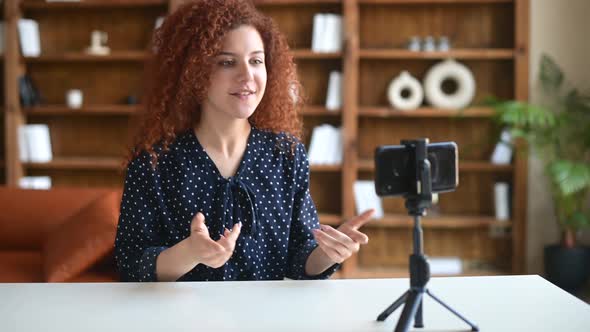 Redhaired Young Curly Woman Blogger Streaming Video Online or Recording Tutorial