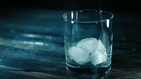 Whiskey Pouring Into a Glass With Ice