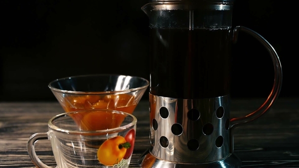 Tea Being Poured Into Glass Tea Cup