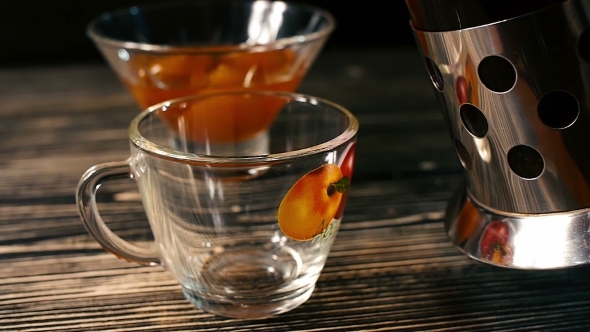 Tea Being Poured Into Glass Tea Cup