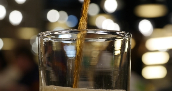 Pouring Cola Drink Into Glass 