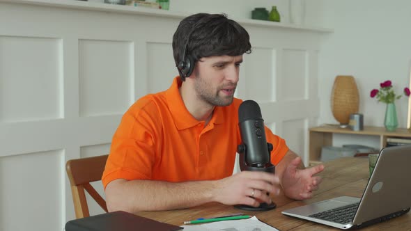 Man Is Speaking in Microphone in Studio Recording Podcast Gesturing Expressing Opinions for Online