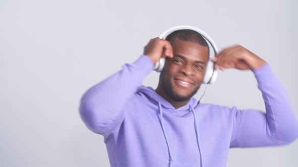 Happy Surprised Hipster Man Listening Music with Headphones at Music Studio