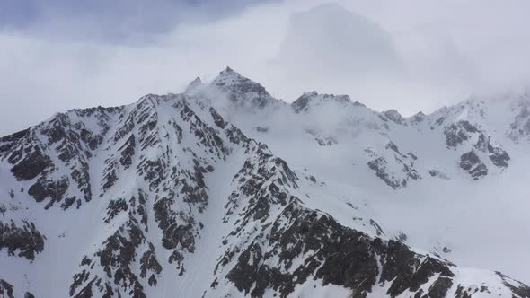 Flight above snowcapped mountains near Elbrus