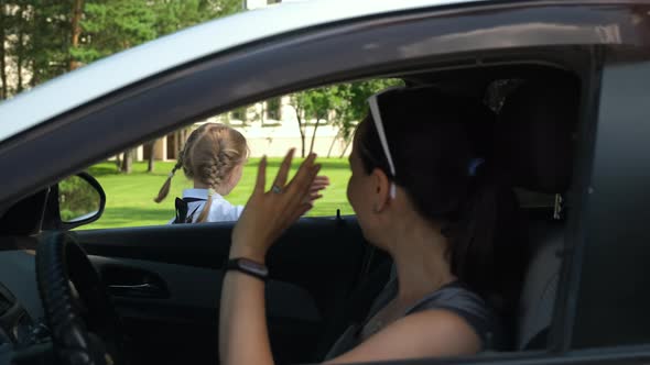 Mother Waving Goodbye at Daughter Before School