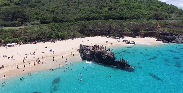 Aerial View of Tourists Cliff Jumping into Turquoise Blue Water