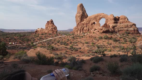 Crane Shot Of A Woman Drinking Water In Arches National Park 5
