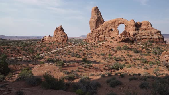 Crane Shot Of A Woman Using Device In Arches National Park