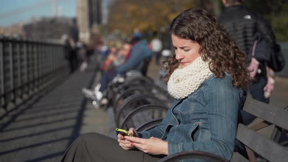 A Beautiful Woman Seated On A Bench Near The Brooklyn Bridge 1