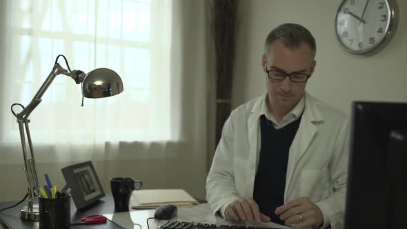 Doctor Working At His Office Desk 10