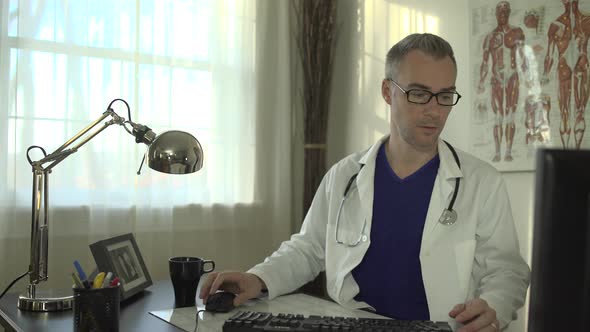 Doctor Working At His Office Desk 17