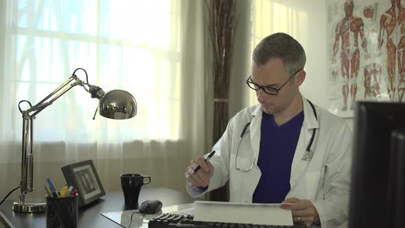 Doctor Working At His Office Desk 21