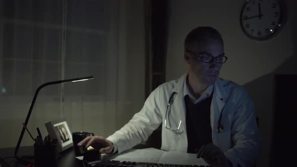 Doctor Working At His Office Desk 3 alt
