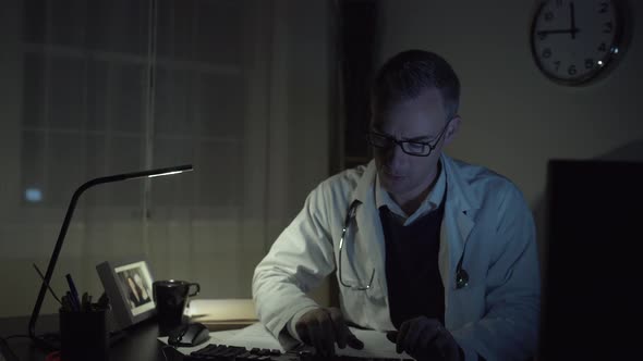 Doctor Working At His Office Desk 4 alt