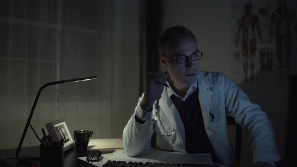 Doctor Working At His Office Desk 5