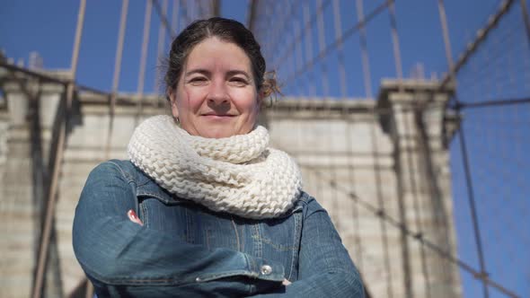 A Beautiful Young Woman Enjoys A Moment On The Brooklyn Bridge alt