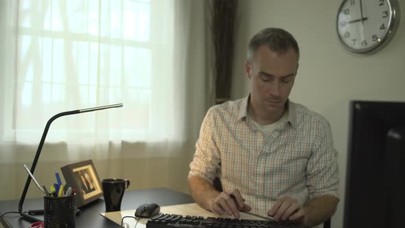 A Man Working At His Office Desk 2 alt
