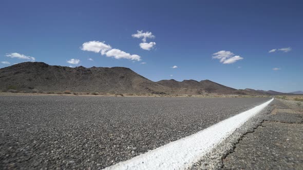 Tumbleweed Blows Across A Road In The Desert 1 Of 2