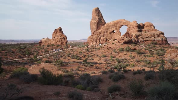 Crane Shot Of A Woman Drinking Water In Arches National Park 2 alt