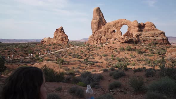 Crane Shot Of A Woman Drinking Water In Arches National Park 4