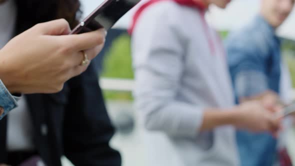 Close up of young people with smart phone 