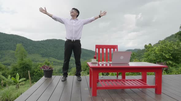 Asian Man Celebrating  With Beautiful Nature