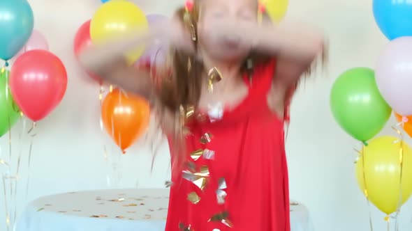 Girl with Ponytails Throws Confetti Celebrating Birthday