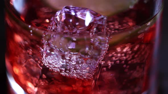 Fizzy soft drink with ice cubes in glass, close-up