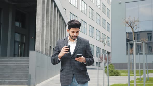 Arabian Man in Business Suit Standing Near Office Building with Modern