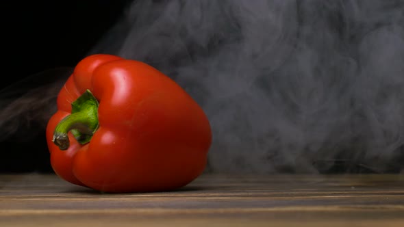 Farm Ripe Capsicum or Sweet Pepper Is on the Table and Smoke Blows From Behind, Cloese Up , Copy