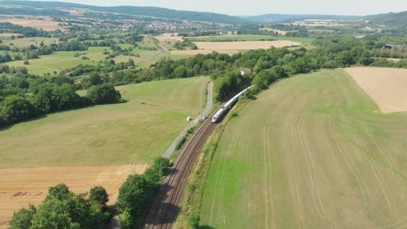 inter city express train cutting through countryside