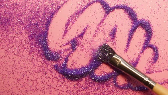 Smearing Glitter on a Pink Background Gloss Powder Closeup