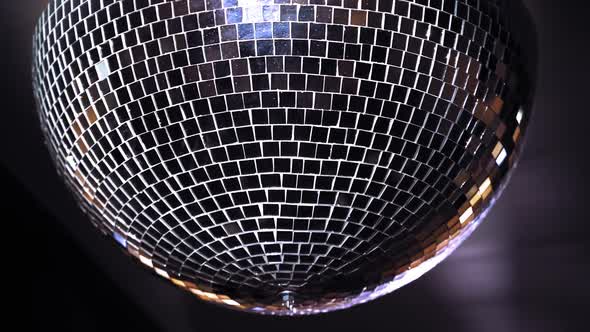 Disco ball on background. Mirror disco ball hanging from the ceiling