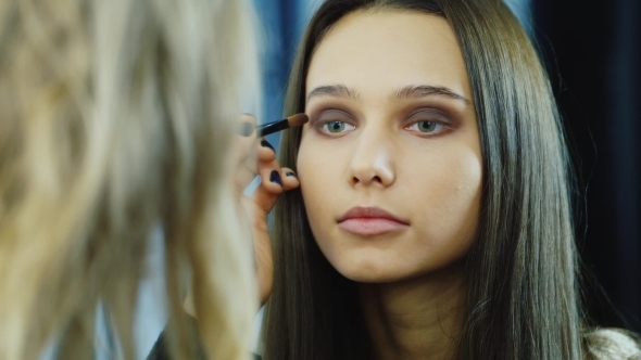 Young Woman Apply Makeup Around The Eyes