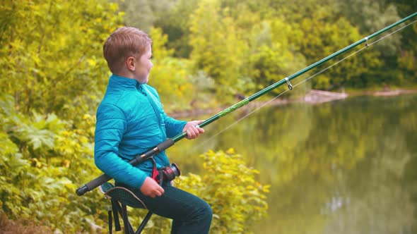 A Little Boy Holding Fishing Rod and Spinning the Roulette