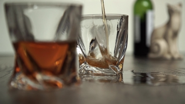 Pouring Whiskey In Two Glasses