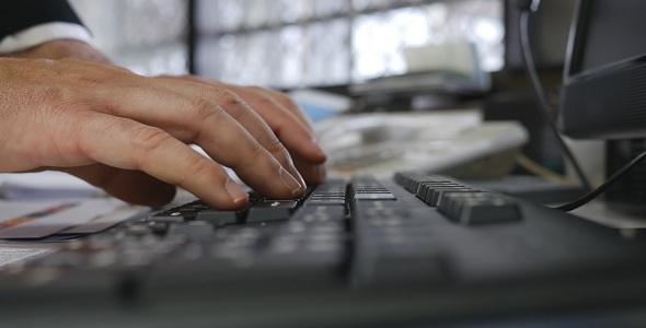 Man Typing on Keyboard in Office