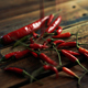 Red Cayenne And Birdseye Chilies Falling On Wooden Table - VideoHive Item for Sale